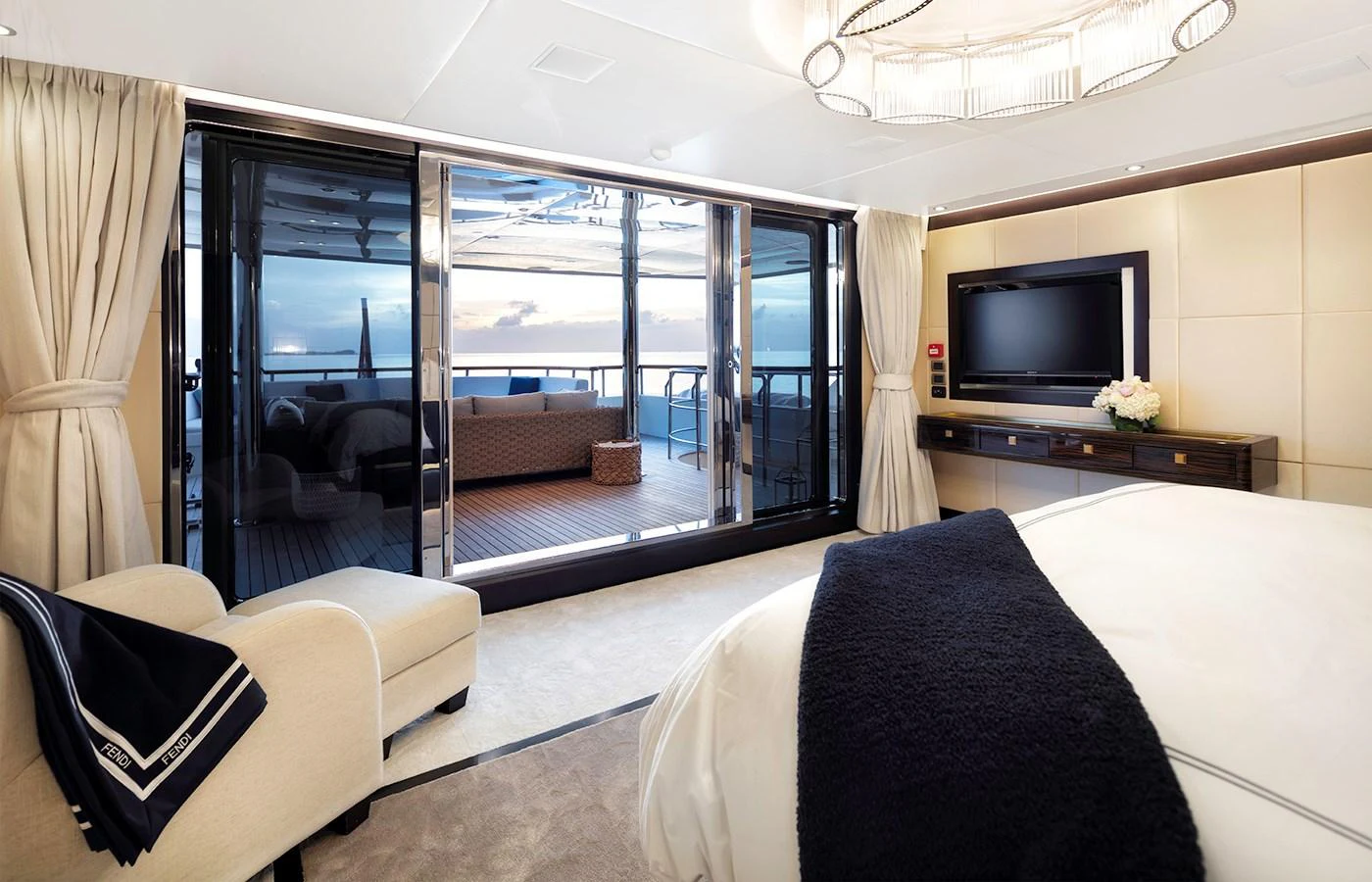 a bedroom with a large glass door aboard MYSTIC Yacht for Charter
