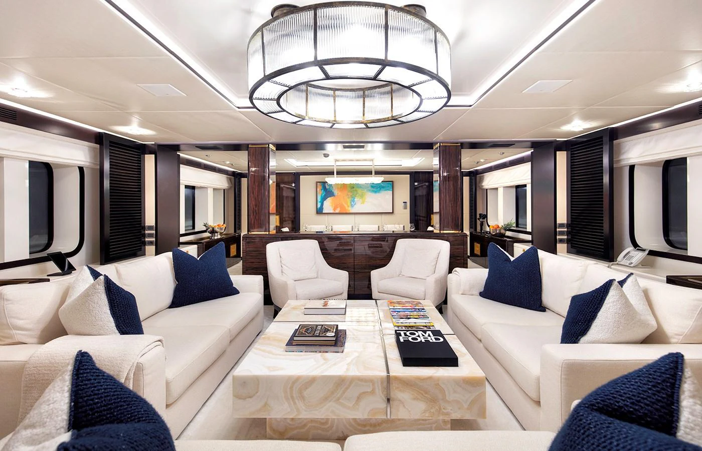 a living room with a large white sofa and a large chandelier aboard MYSTIC Yacht for Charter