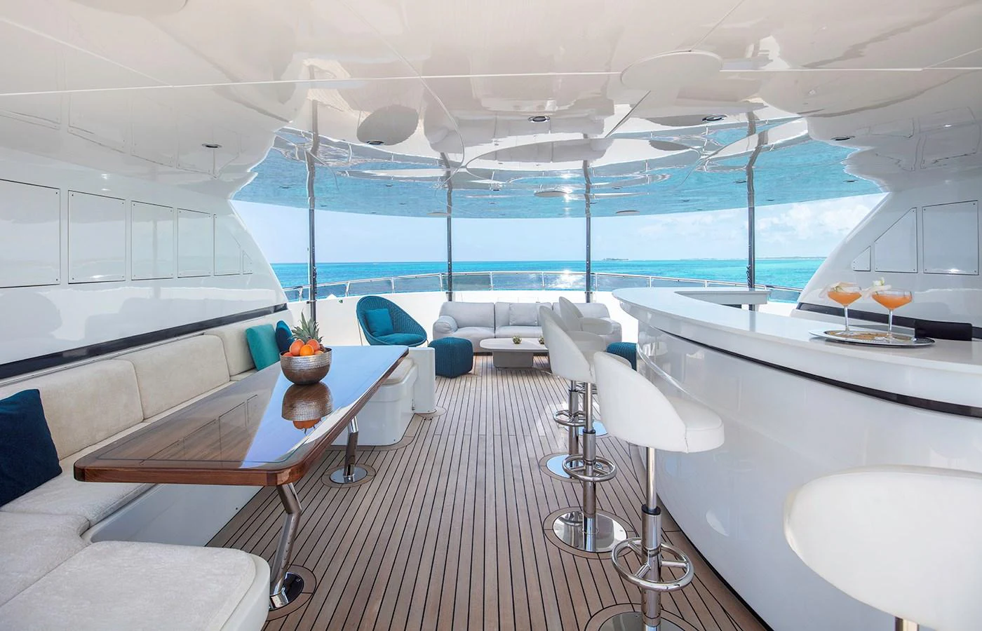 a room with a table chairs and a view of the ocean aboard MYSTIC Yacht for Charter