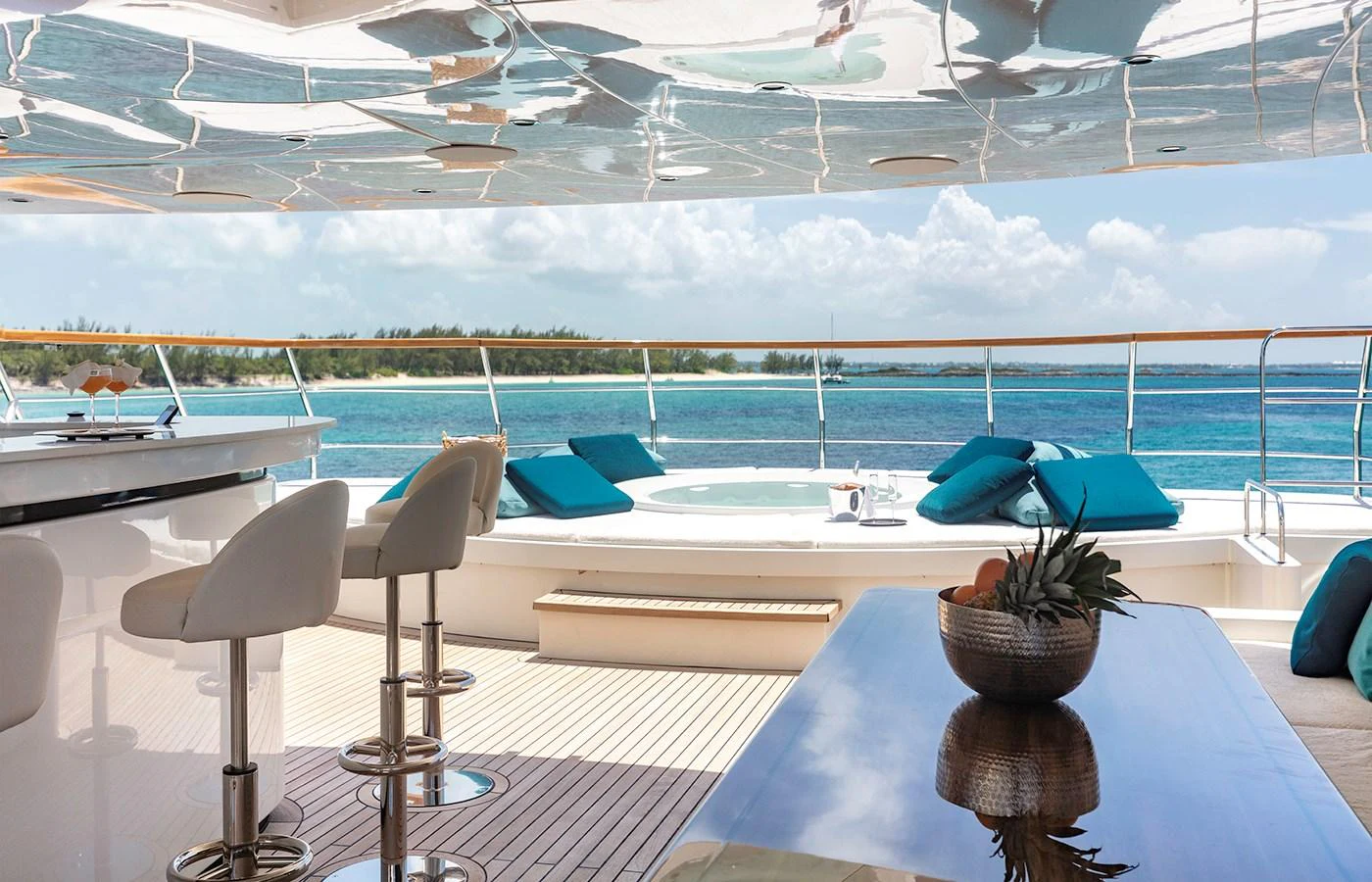 a table with chairs and a plant on it aboard MYSTIC Yacht for Charter