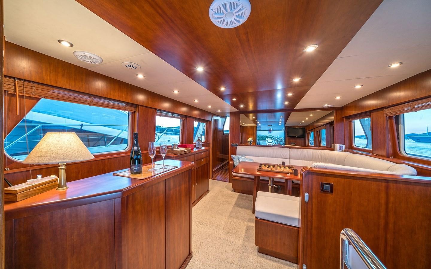 a room with a bar and a tv on the wall aboard LACROMA Yacht for Sale