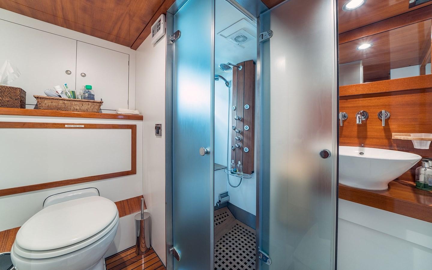 a bathroom with a shower and sink aboard LACROMA Yacht for Sale