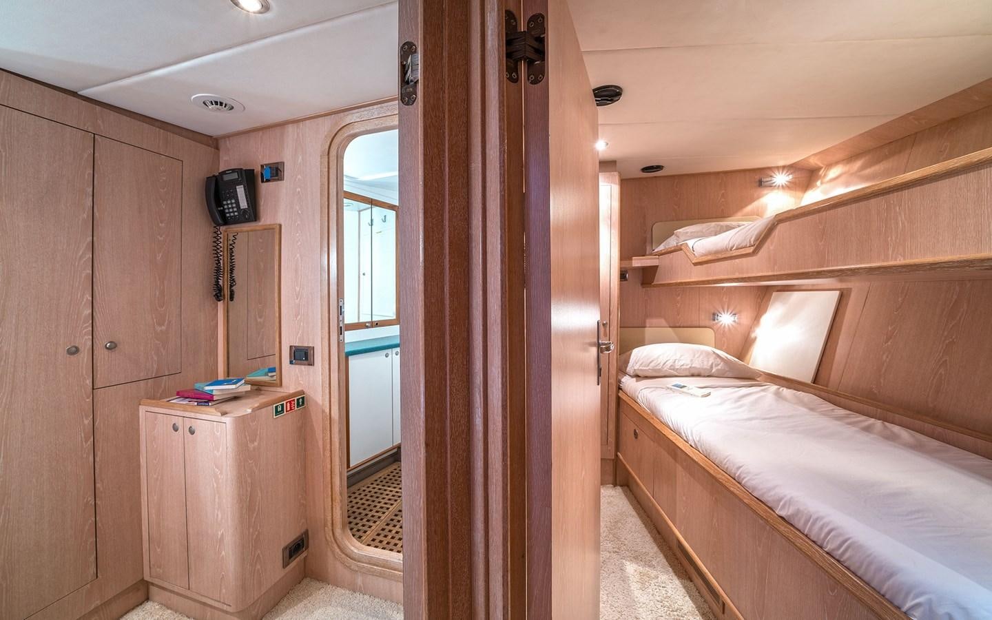 a bedroom with a bed and a closet aboard LACROMA Yacht for Sale