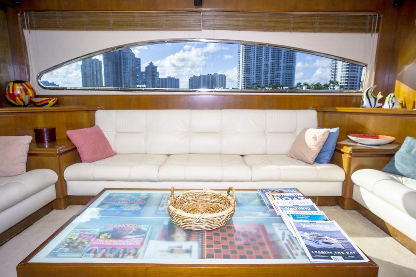 a living room with a large window aboard KARTESSA III Yacht for Sale