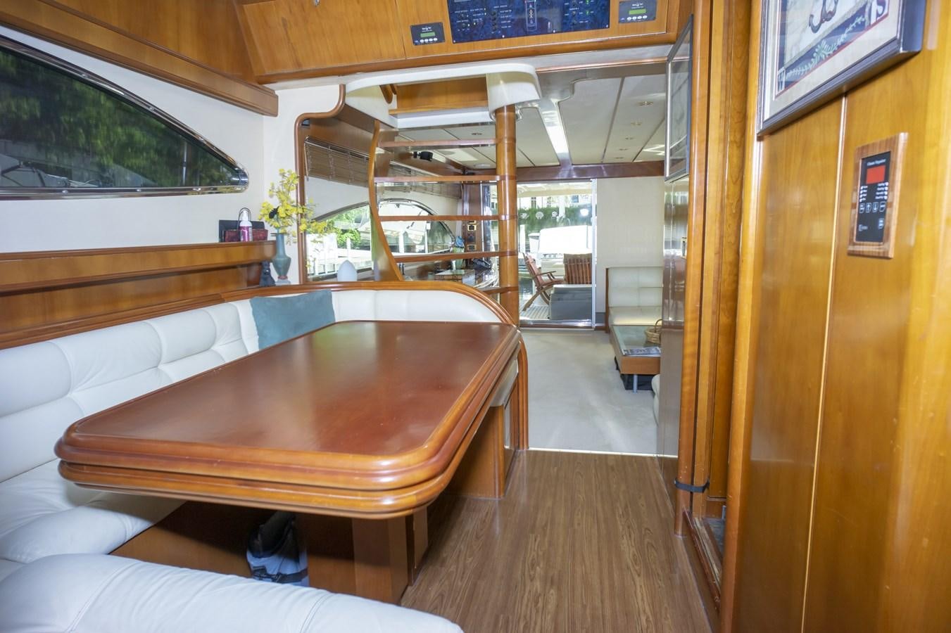 a room with a table and couch aboard KARTESSA III Yacht for Sale