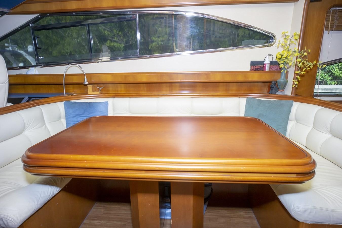 a table with a bench aboard KARTESSA III Yacht for Sale