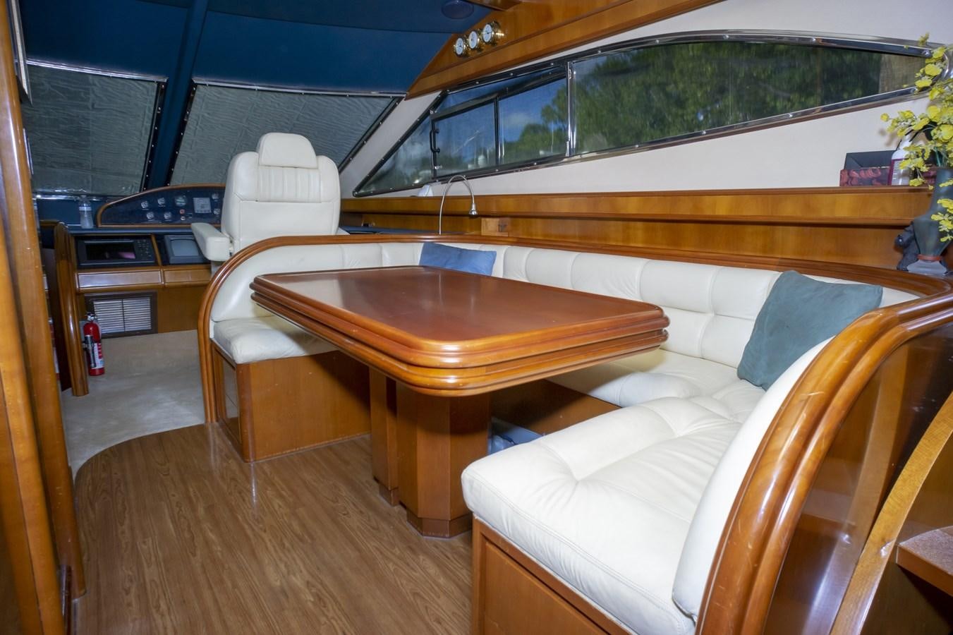 a room with a table and chairs aboard KARTESSA III Yacht for Sale