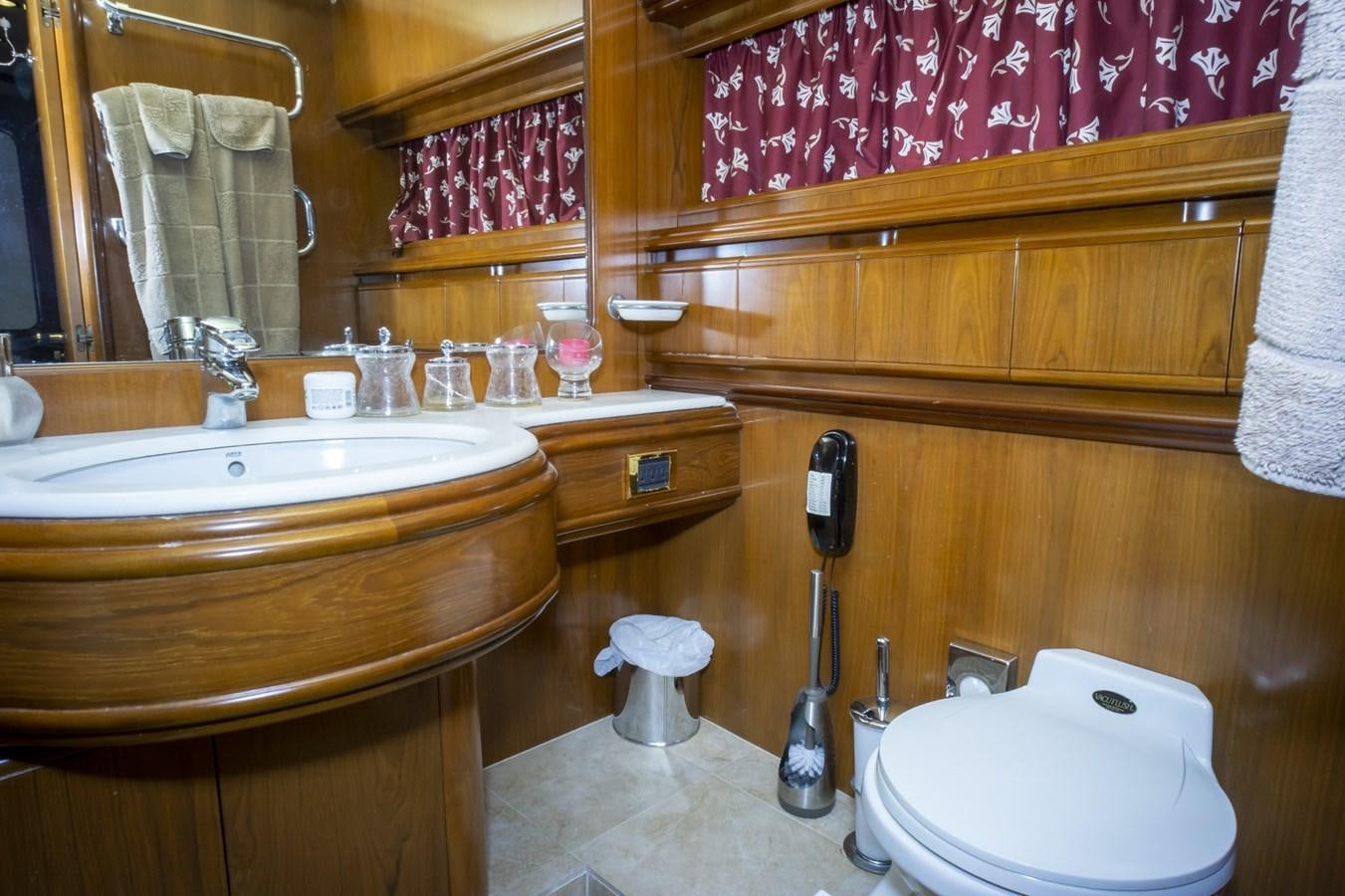 a bathroom with a toilet and sink aboard KARTESSA III Yacht for Sale