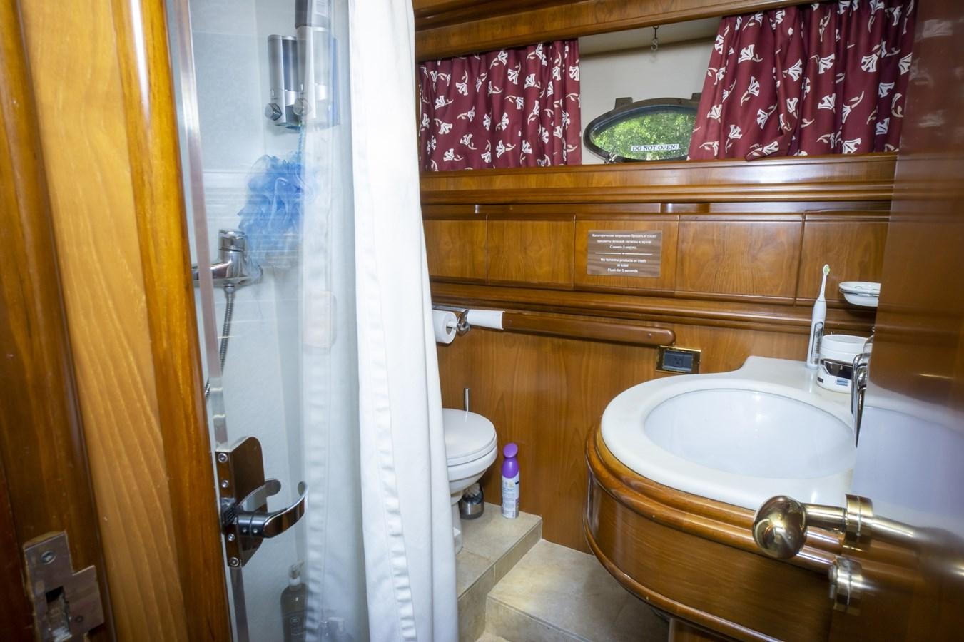 a bathroom with a sink and a toilet aboard KARTESSA III Yacht for Sale