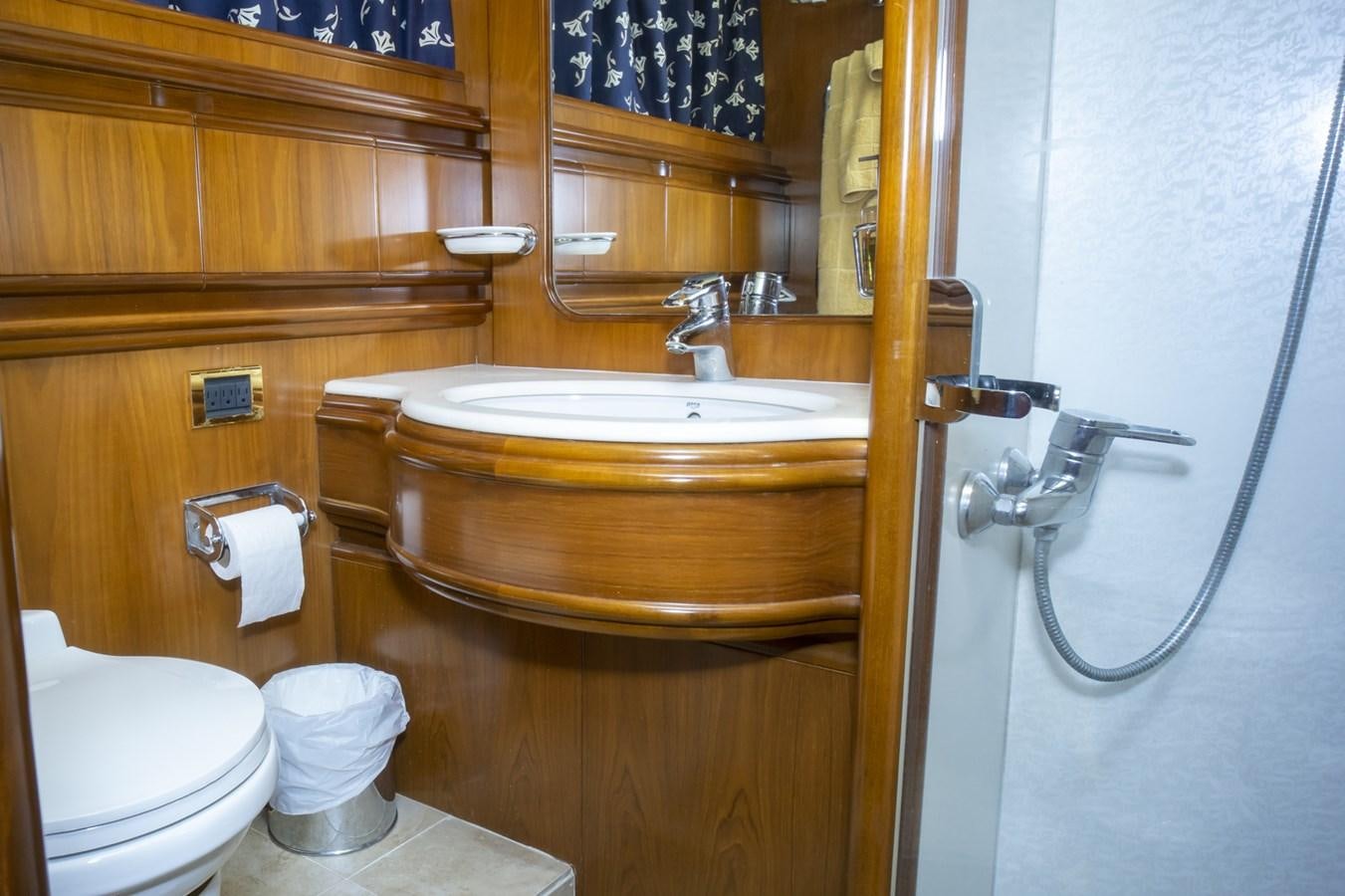 a bathroom with a sink and toilet aboard KARTESSA III Yacht for Sale