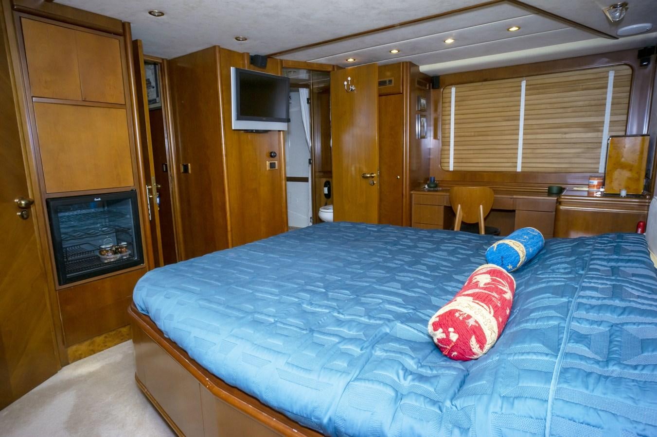 a bedroom with a blue bed aboard KARTESSA III Yacht for Sale