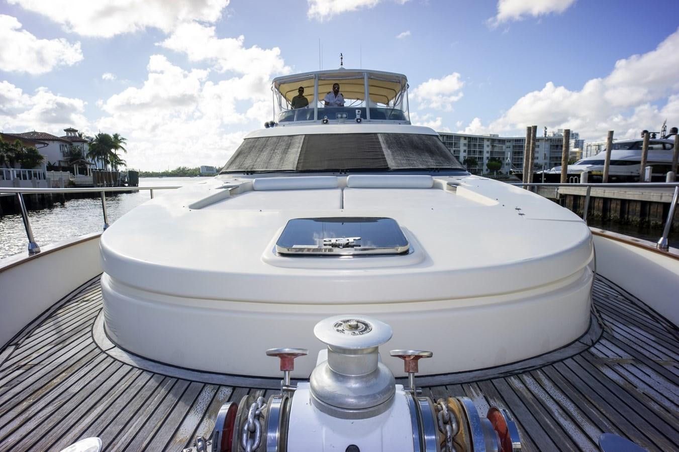 a white yacht on a dock aboard KARTESSA III Yacht for Sale