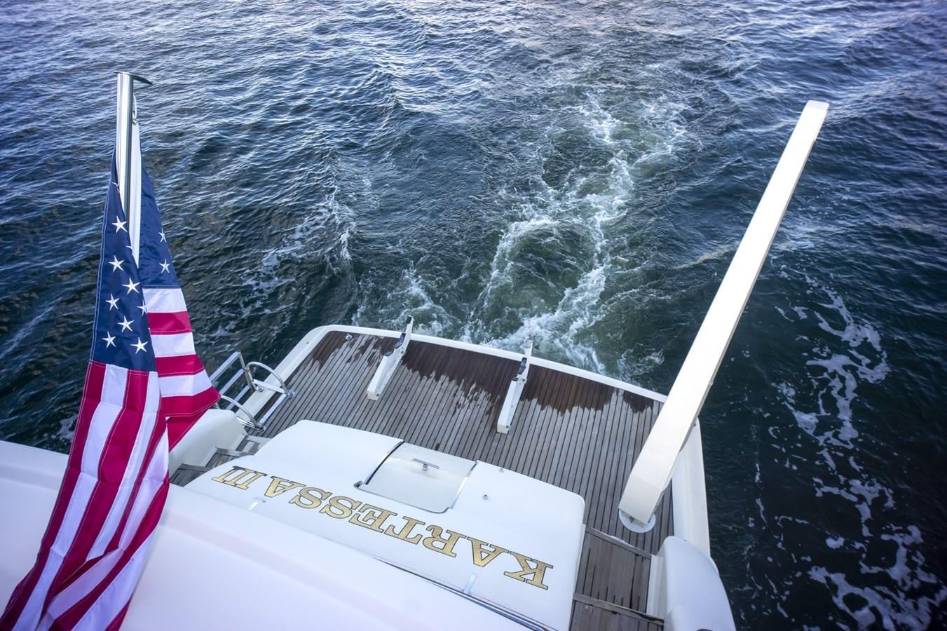 a boat with a flag on it aboard KARTESSA III Yacht for Sale