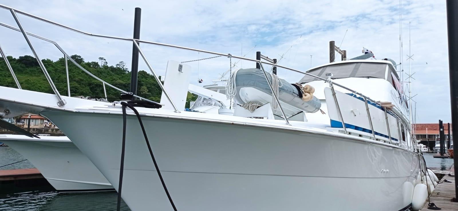 a white boat with a person on it aboard IN FLIGHT Yacht for Sale