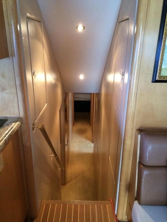 a hallway with a door and a chair aboard IN FLIGHT Yacht for Sale