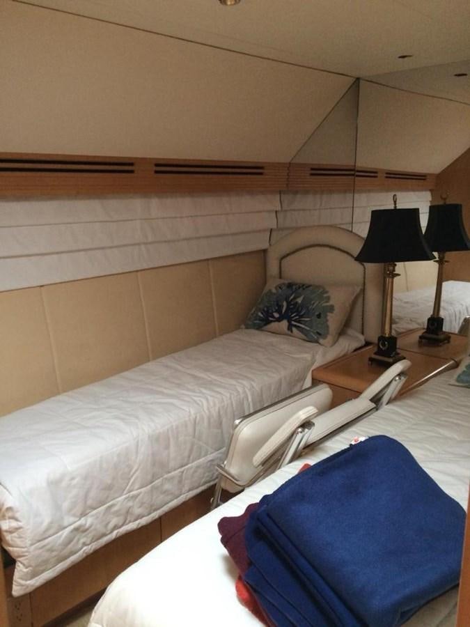 a bed with a lamp on it aboard IN FLIGHT Yacht for Sale