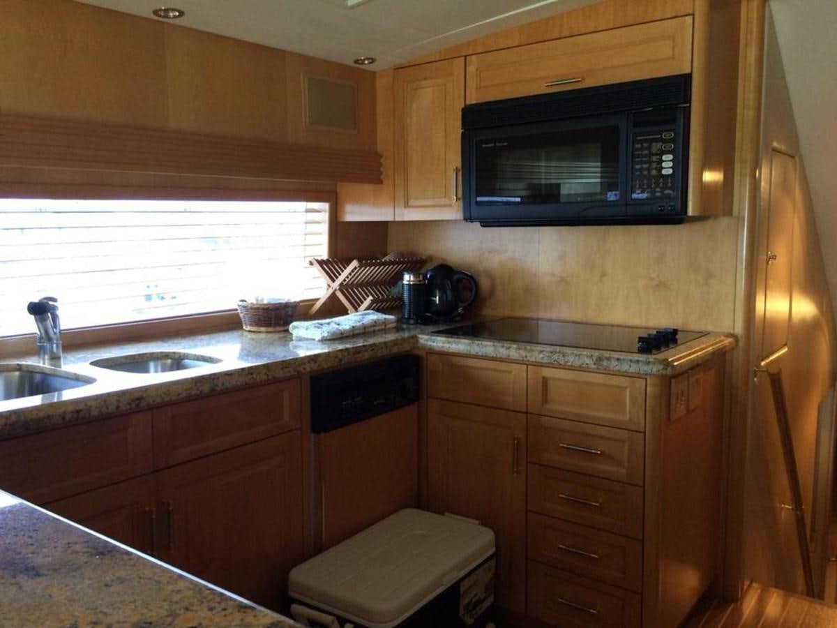 a kitchen with wooden cabinets aboard IN FLIGHT Yacht for Sale