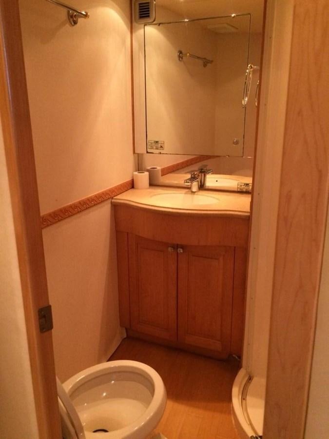 a bathroom with a toilet and sink aboard IN FLIGHT Yacht for Sale