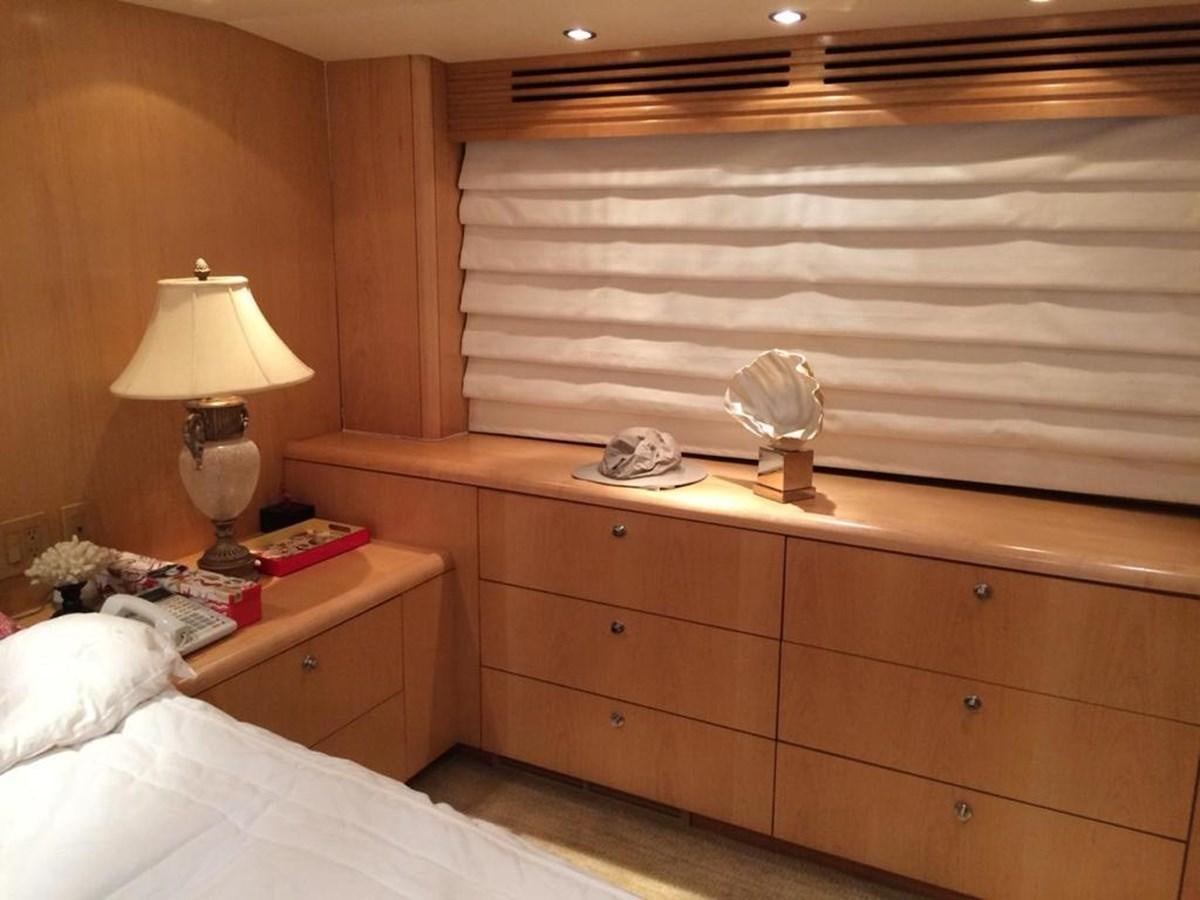 a bed with a lamp and a mirror aboard IN FLIGHT Yacht for Sale