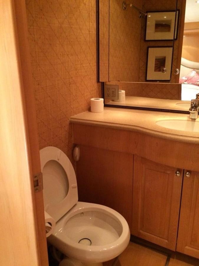 a bathroom with a toilet and sink aboard IN FLIGHT Yacht for Sale