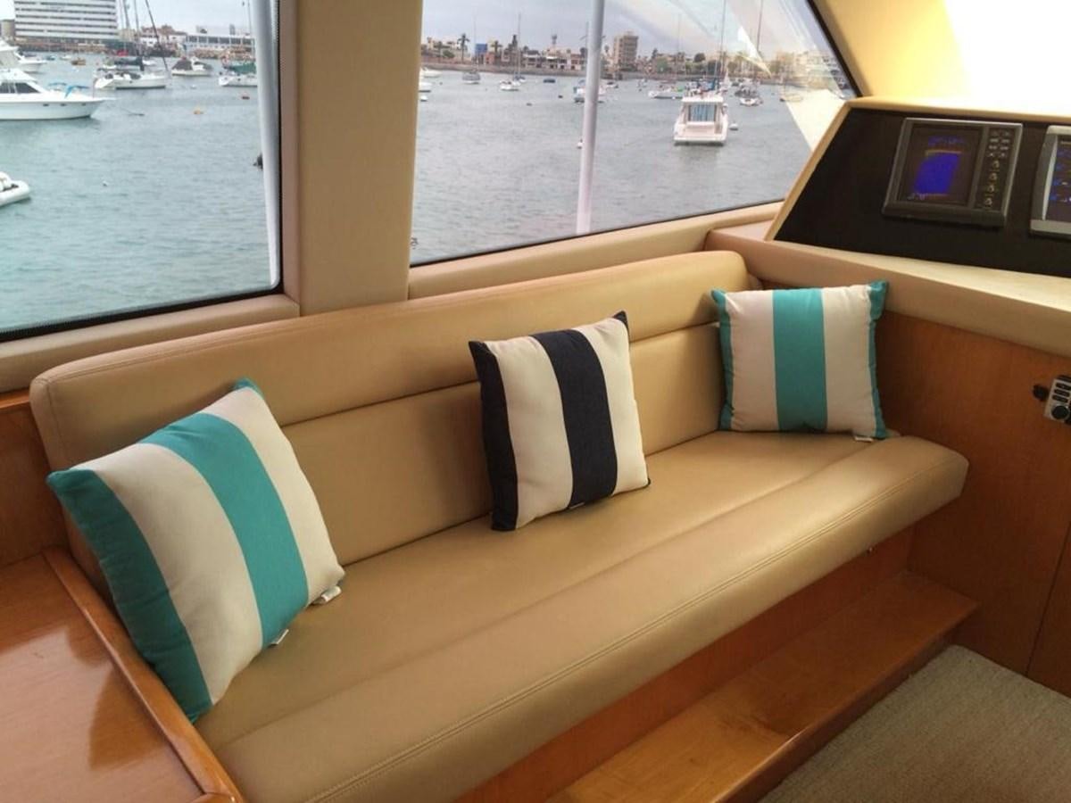 a couch with pillows on it aboard IN FLIGHT Yacht for Sale