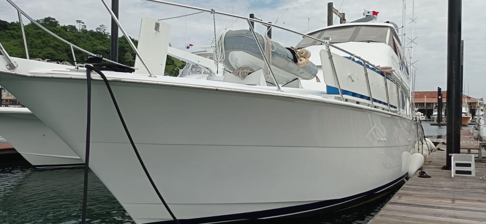 a white boat docked aboard IN FLIGHT Yacht for Sale