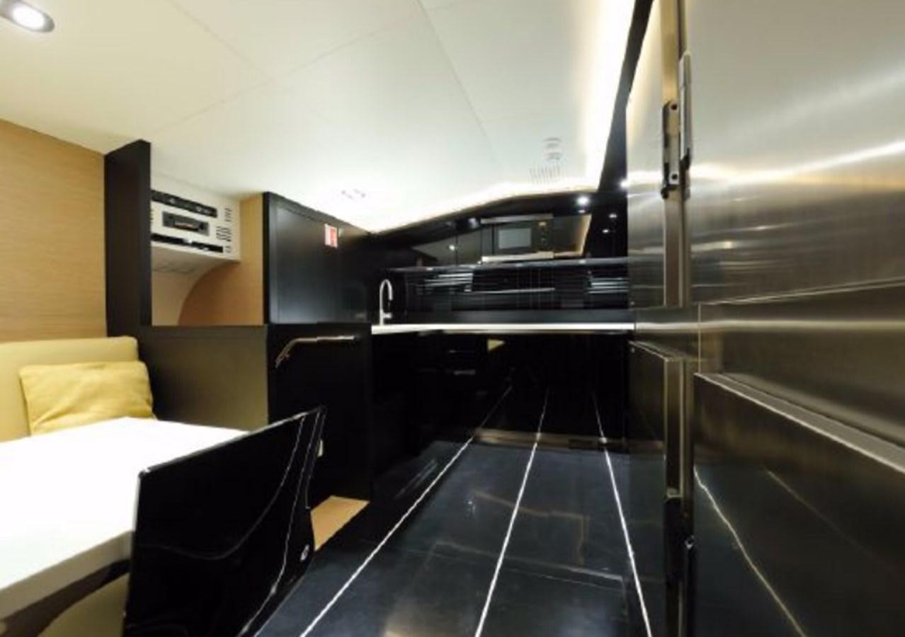 a large stainless steel refrigerator in a kitchen aboard BERTONA III Yacht for Sale
