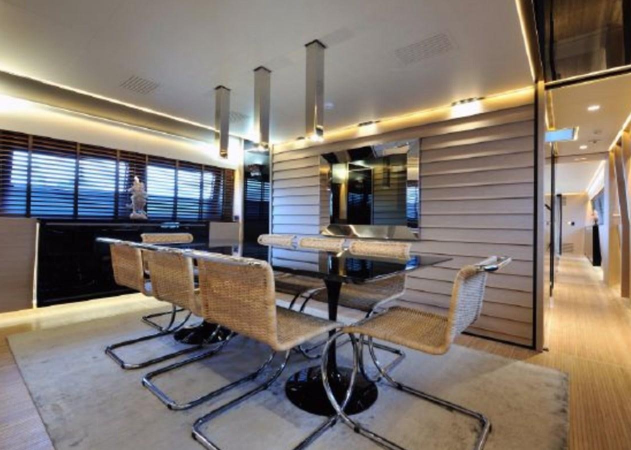 a room with a table and chairs aboard BERTONA III Yacht for Sale