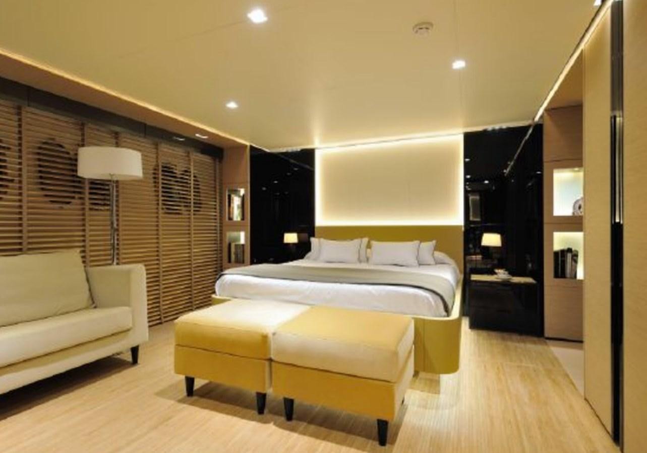a bedroom with a bed and a desk aboard BERTONA III Yacht for Sale