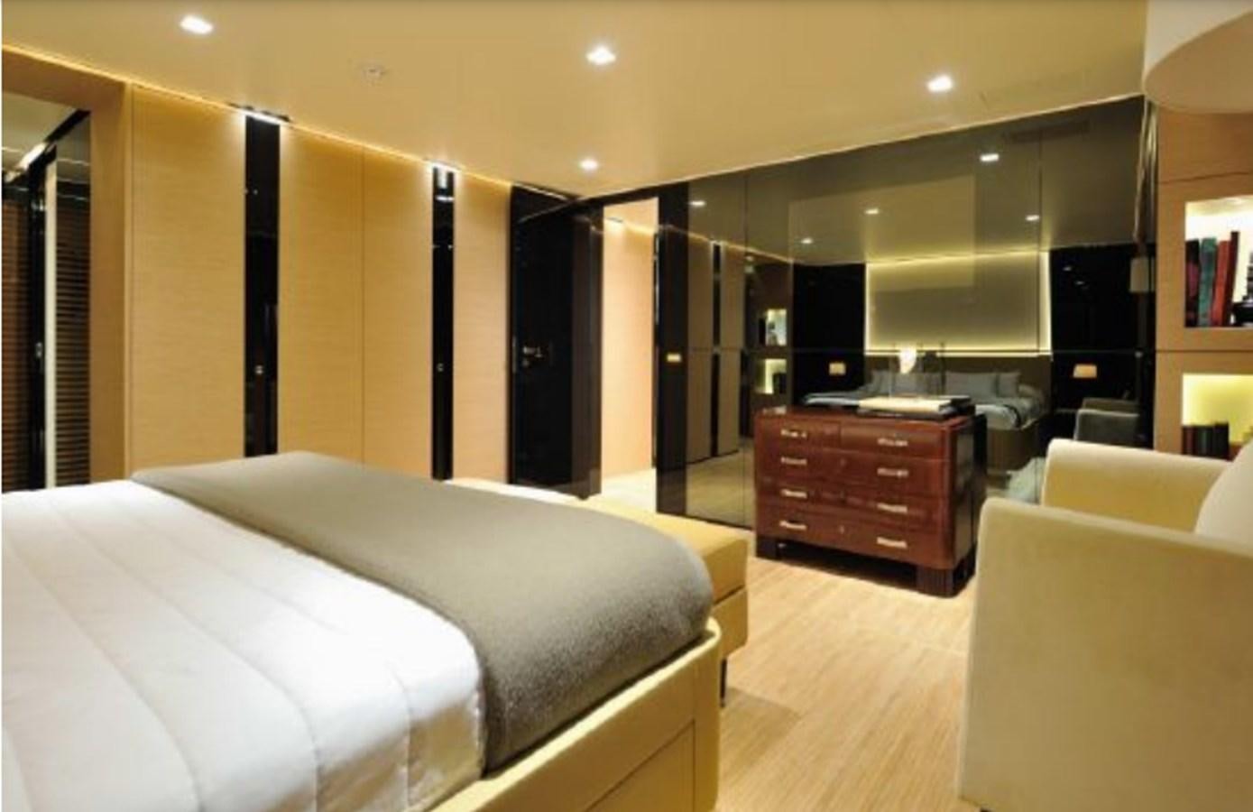 a room with a bed and a dresser aboard BERTONA III Yacht for Sale