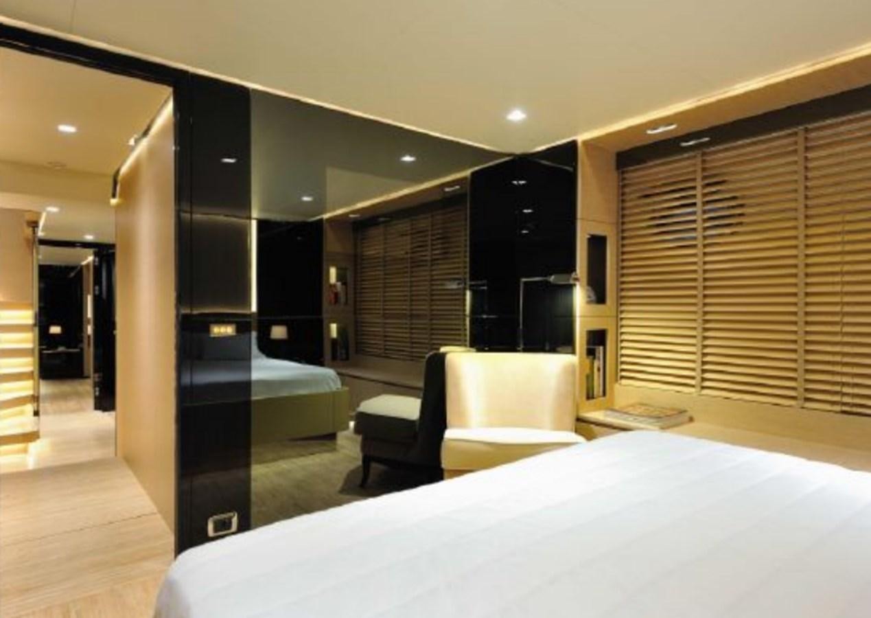 a room with a bed and a desk aboard BERTONA III Yacht for Sale