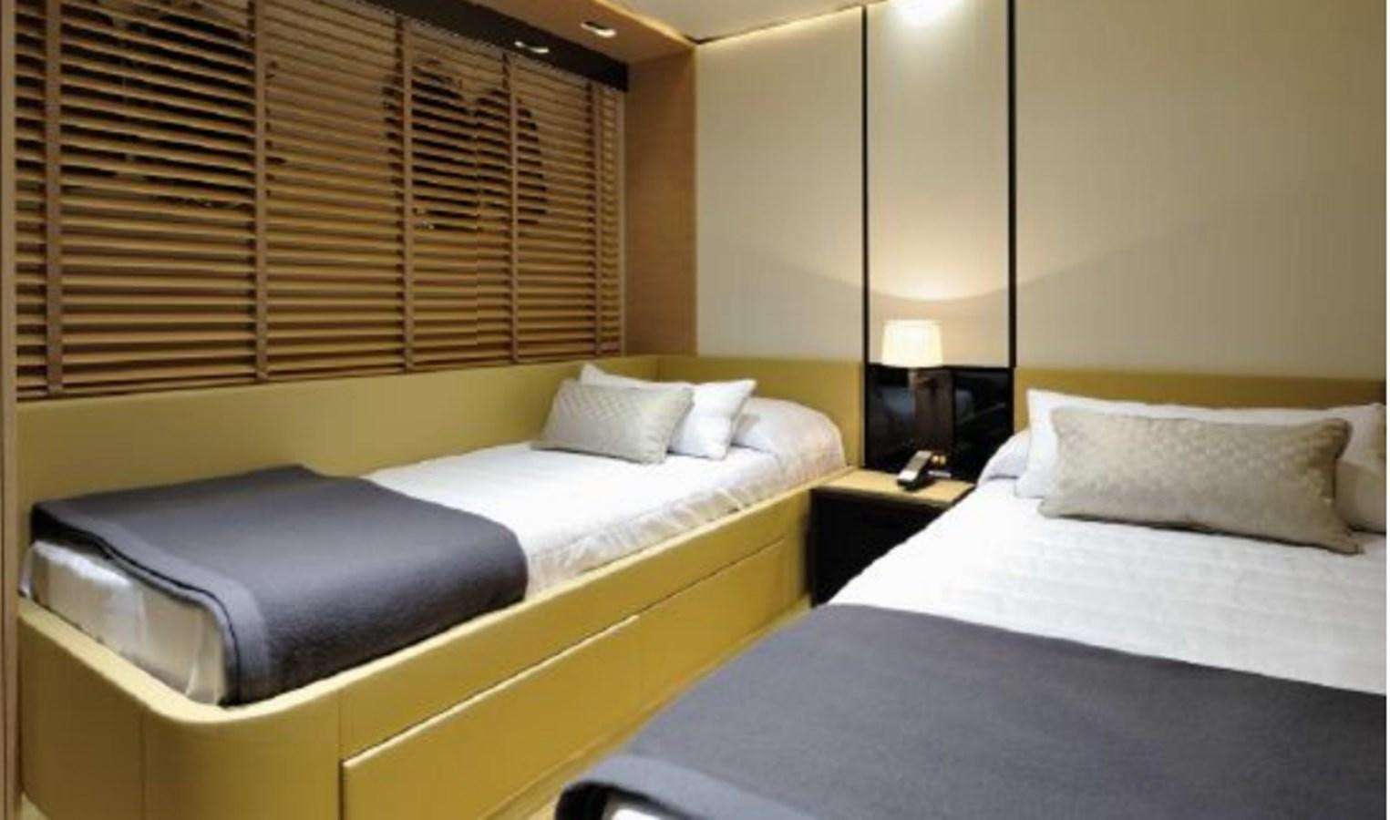a couple of beds in a hotel room aboard BERTONA III Yacht for Sale