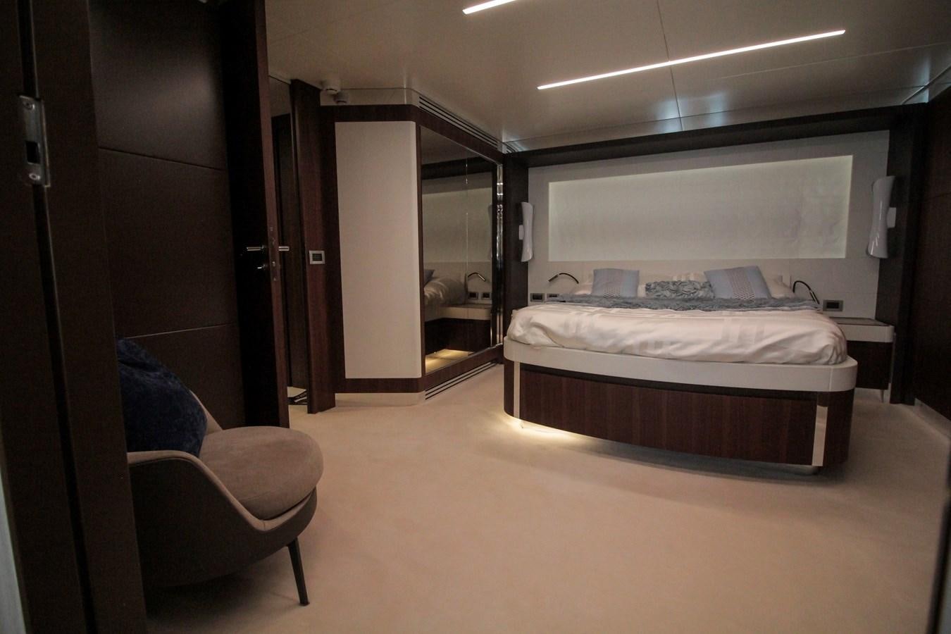 a room with a bed and a chair aboard SEDA Yacht for Sale