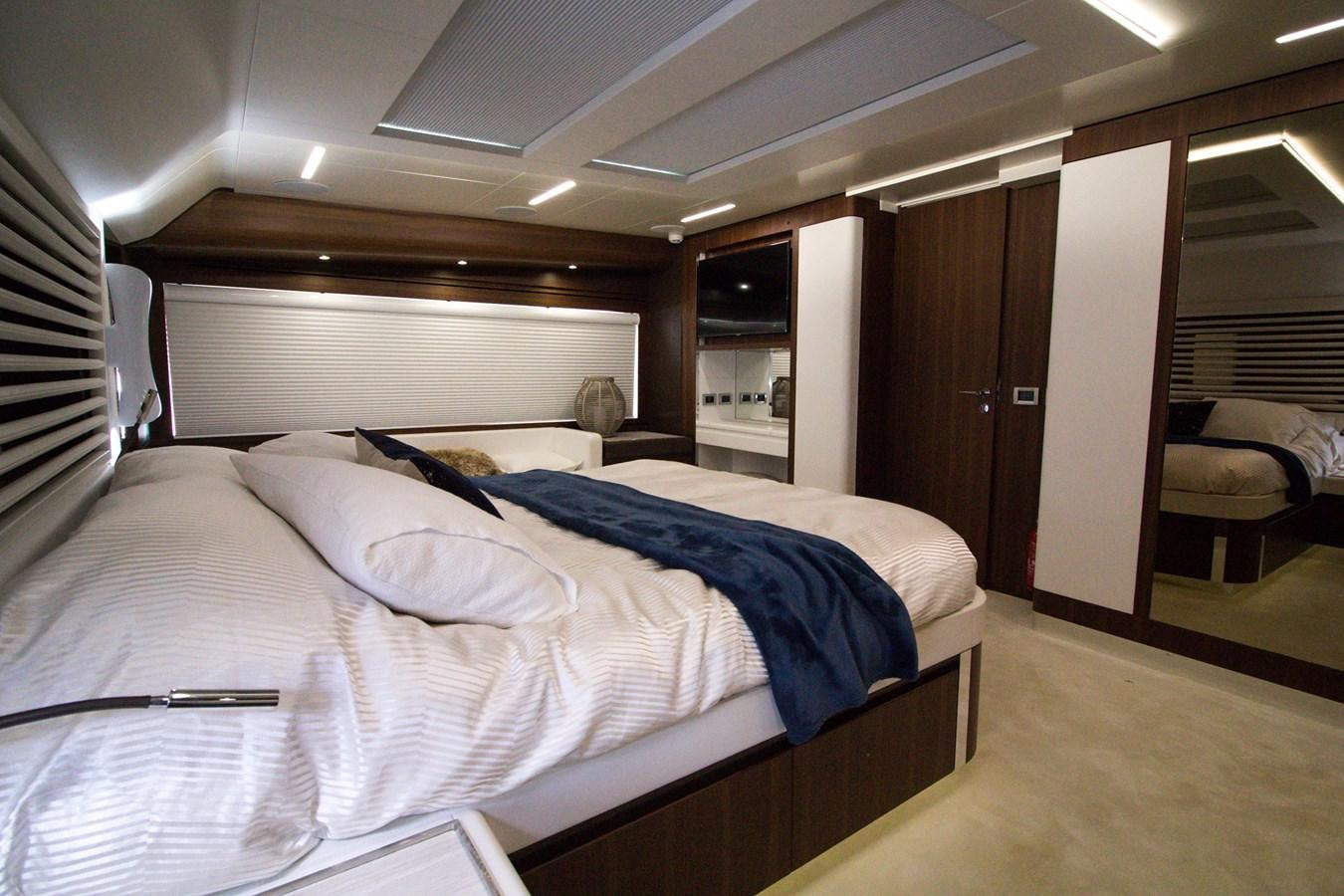 a room with a bed and a chair aboard SEDA Yacht for Sale