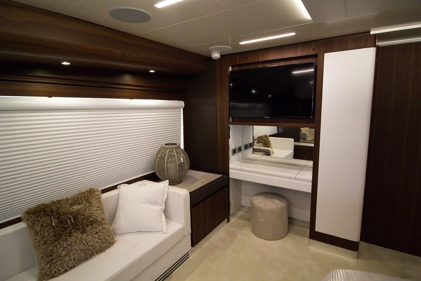 a room with a bed and a shelf with a mirror aboard SEDA Yacht for Sale