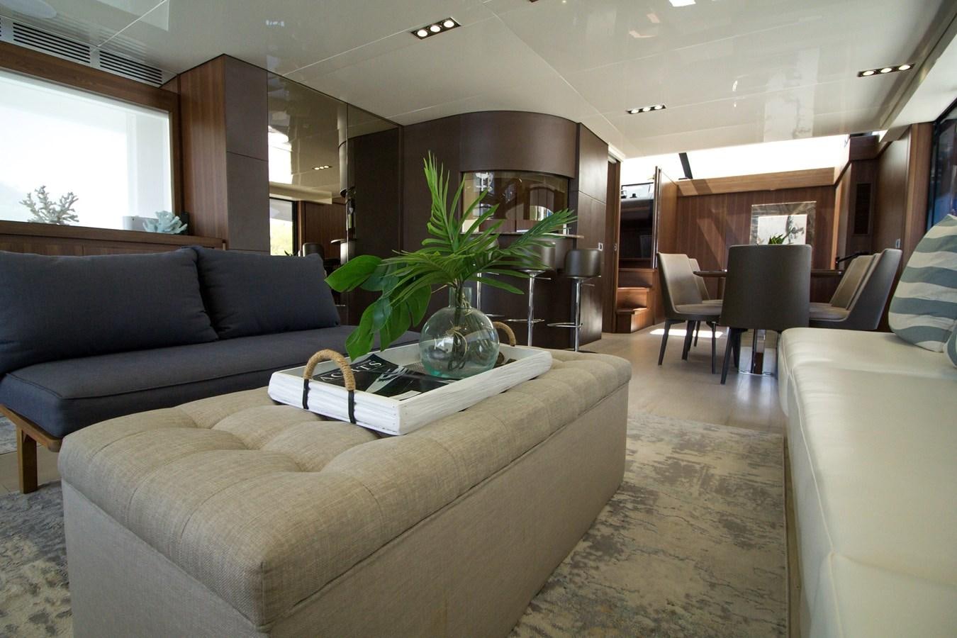 a living room with a couch and a plant in it aboard SEDA Yacht for Sale