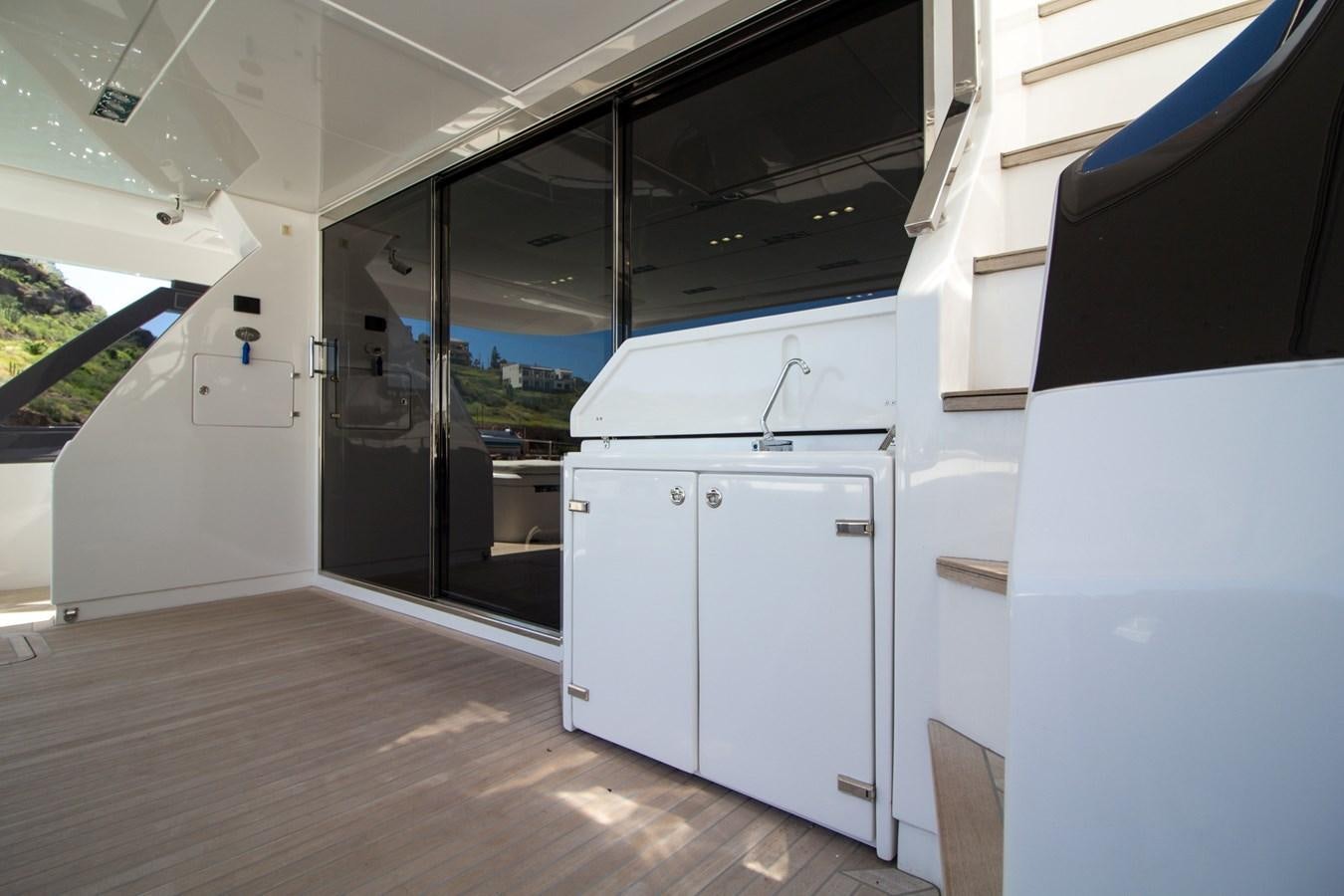 a room with a large window and a large door aboard SEDA Yacht for Sale
