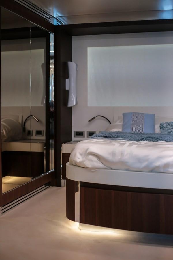 a bedroom with a bed and a mirror aboard SEDA Yacht for Sale