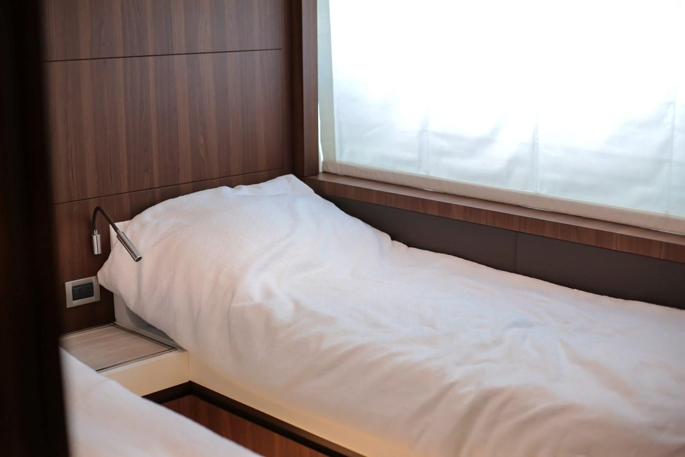 a bed with a white sheet aboard SEDA Yacht for Sale