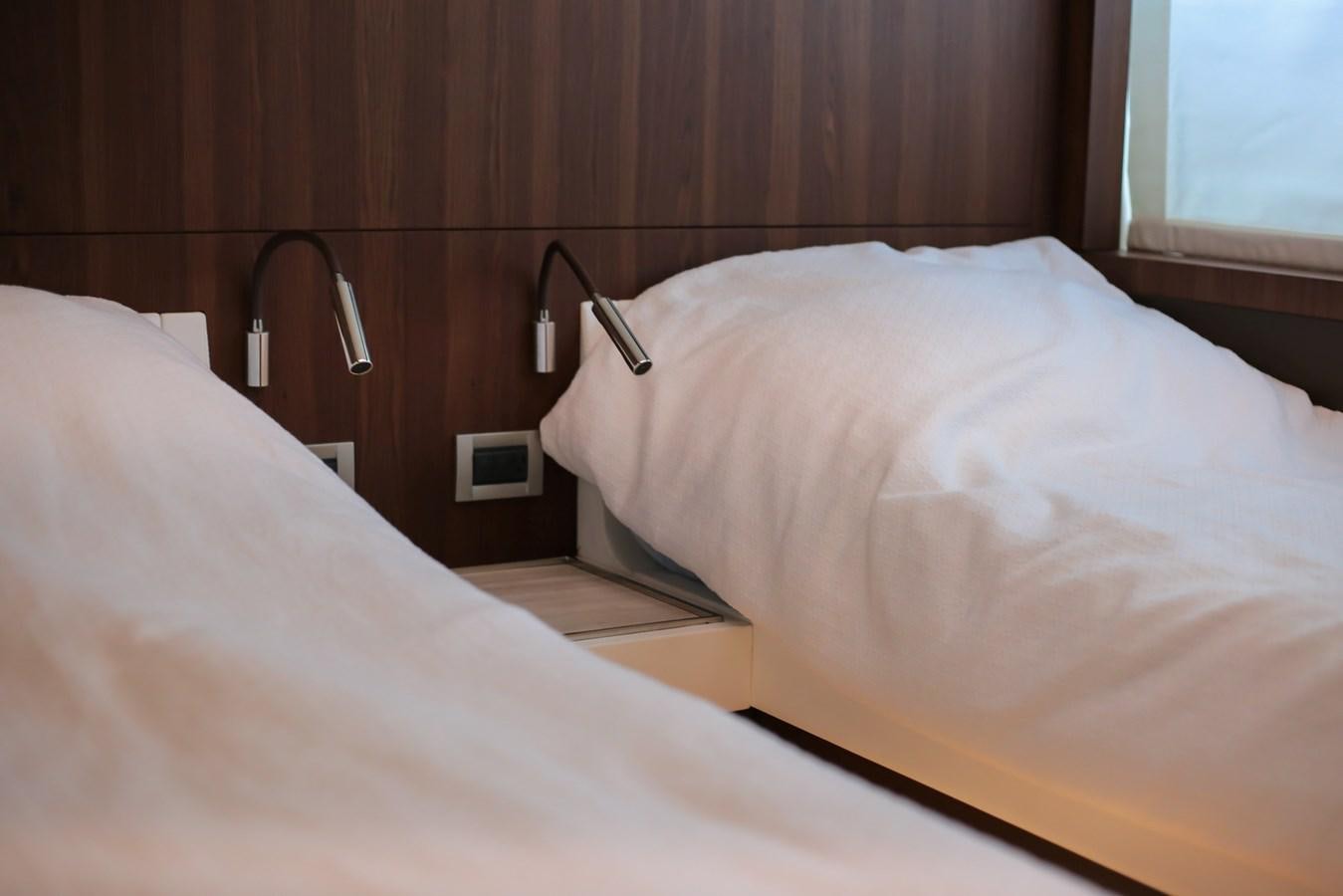 a bed with a white sheet aboard SEDA Yacht for Sale