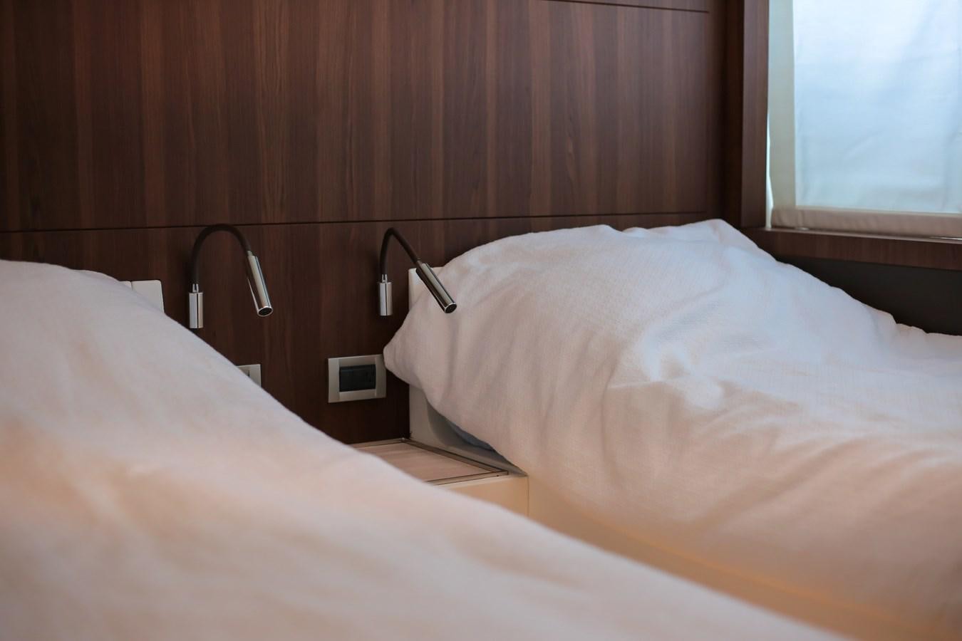 a bed with a white sheet aboard SEDA Yacht for Sale