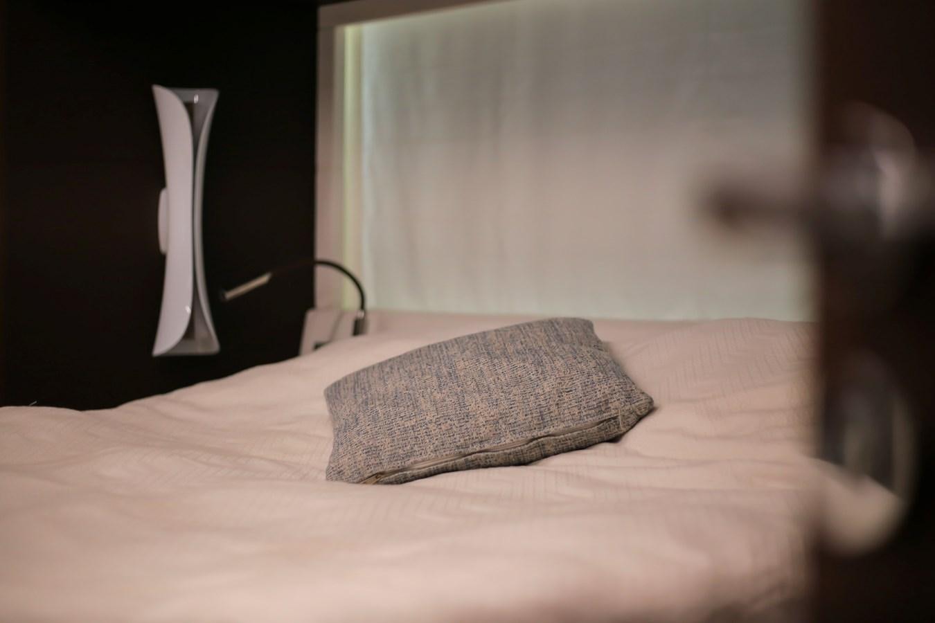 a bed with a pillow and a lamp on it aboard SEDA Yacht for Sale