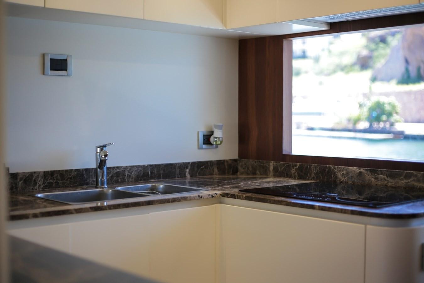 a kitchen with a sink and a window aboard SEDA Yacht for Sale