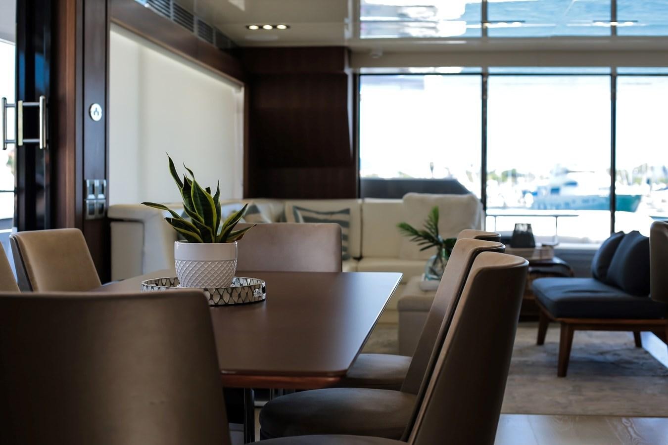 a room with tables and chairs aboard SEDA Yacht for Sale