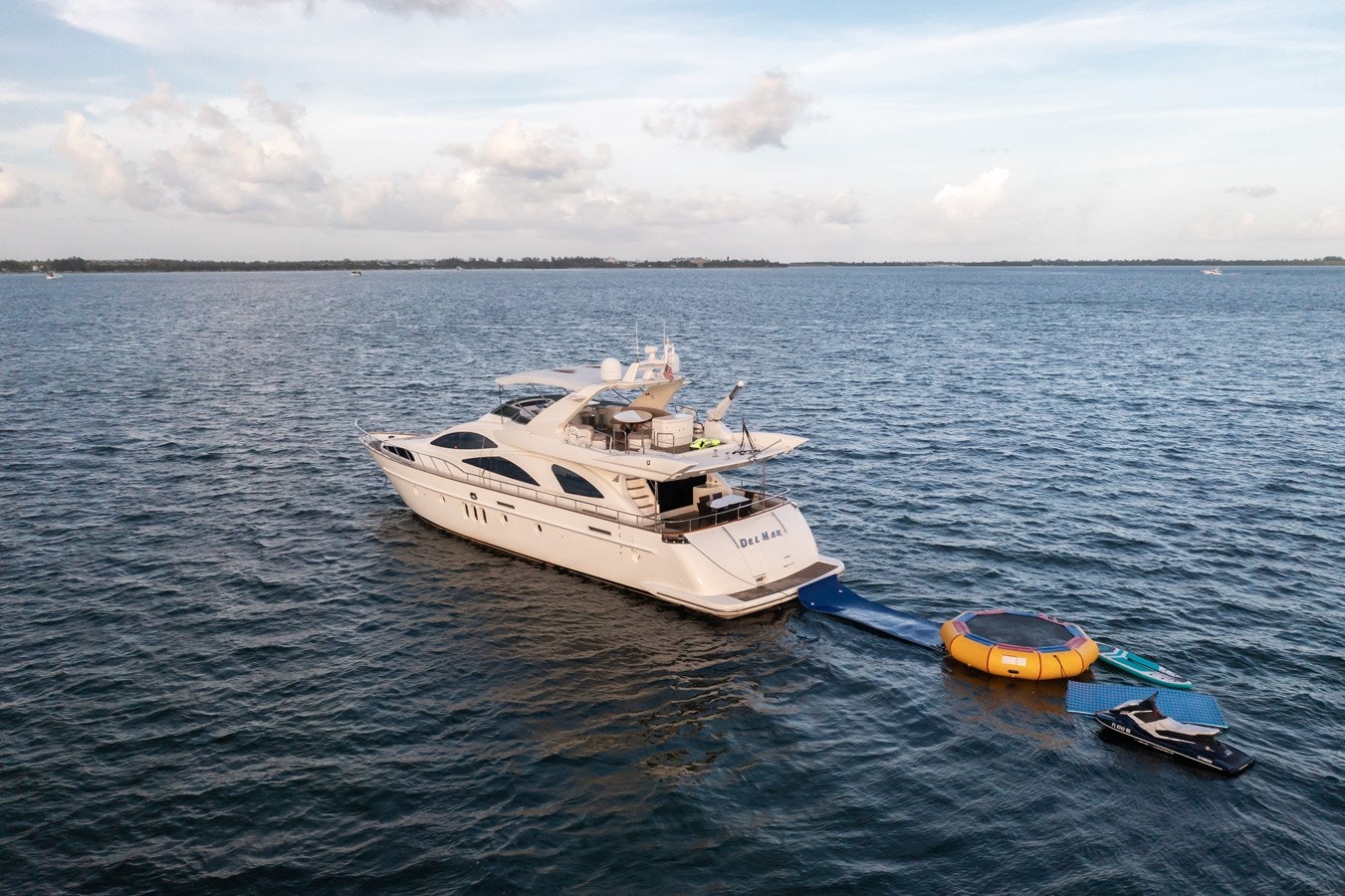 a boat and a motor boat in the water aboard AZIMUT 80 2003 Yacht for Sale