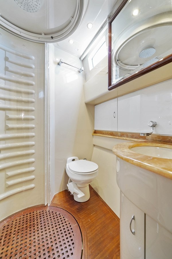 a bathroom with a sink toilet and a mirror aboard AZIMUT 80 2003 Yacht for Sale