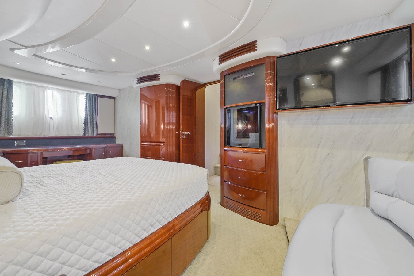 a bedroom with a bed and a television aboard AZIMUT 80 2003 Yacht for Sale