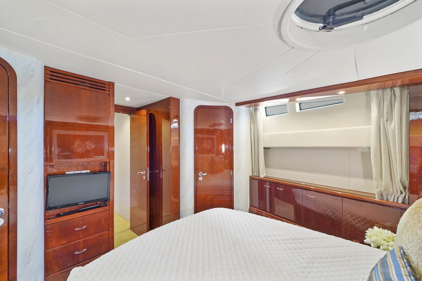 a bedroom with a bed and a television aboard AZIMUT 80 2003 Yacht for Sale