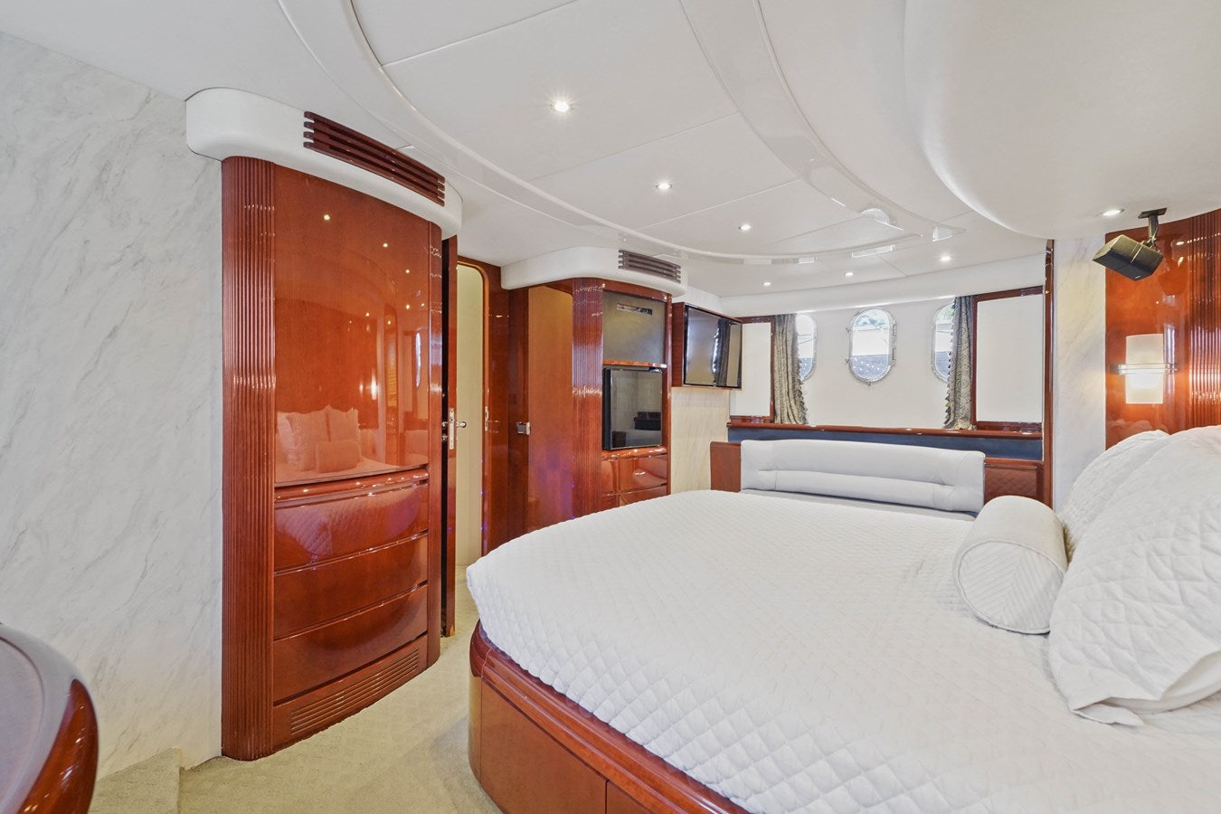 a bedroom with a bed and a closet aboard AZIMUT 80 2003 Yacht for Sale