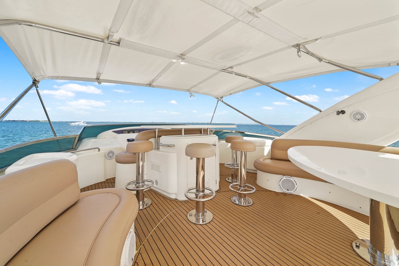 a boat with stools and chairs aboard AZIMUT 80 2003 Yacht for Sale